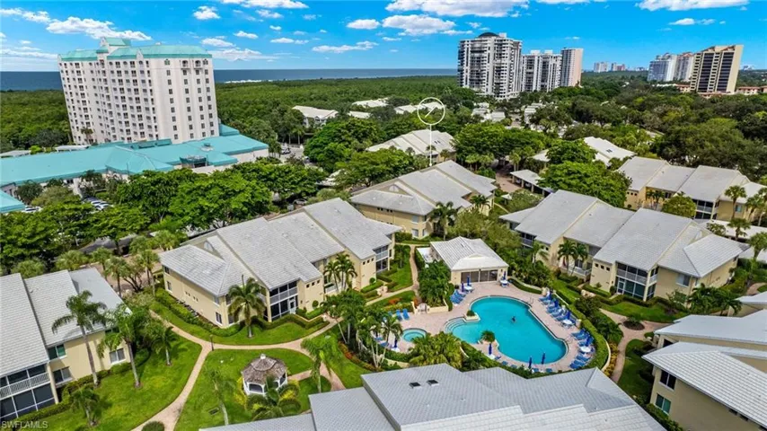 Birds eye view of property with a water view