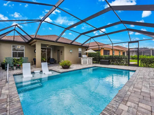 View of pool with ceiling fan, a patio area, and a lanai
