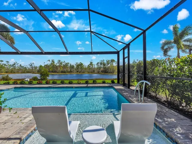 View of swimming pool featuring a water view, a patio area, and a lanai