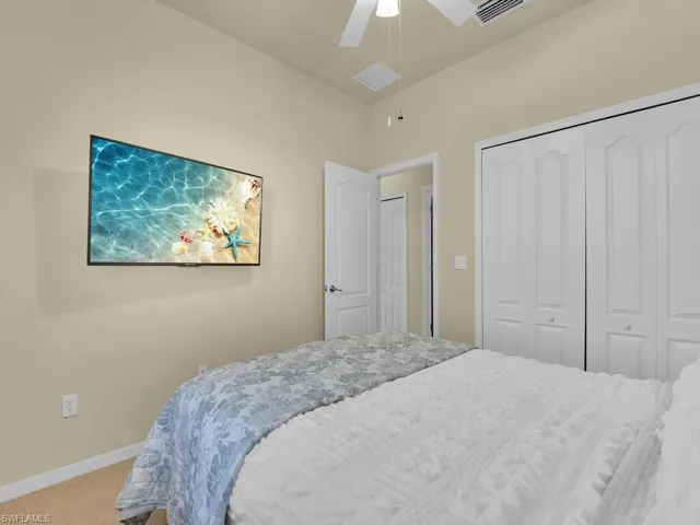 Bedroom with carpet, a closet, and ceiling fan