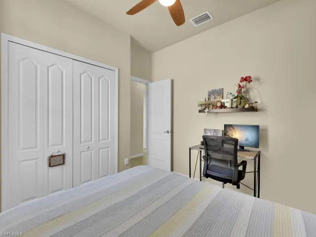 Bedroom featuring ceiling fan and a closet