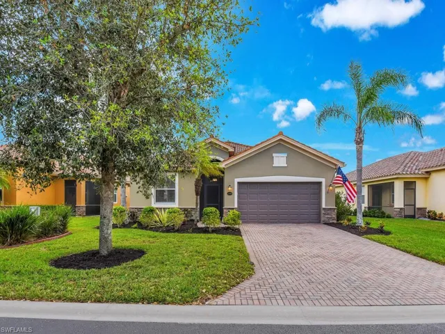 View of front of property with a front lawn and a garage