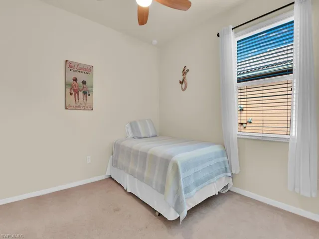 Bedroom featuring ceiling fan and light carpet