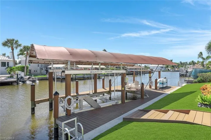 Dock with boat lift and a water view