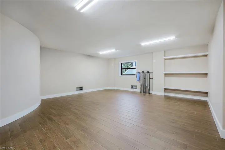 Basement featuring wood finished floors and baseboards