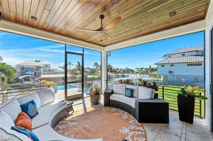 Sunroom / solarium featuring an outdoor hangout area, ceiling fan, a water view, and healthy amount of natural light