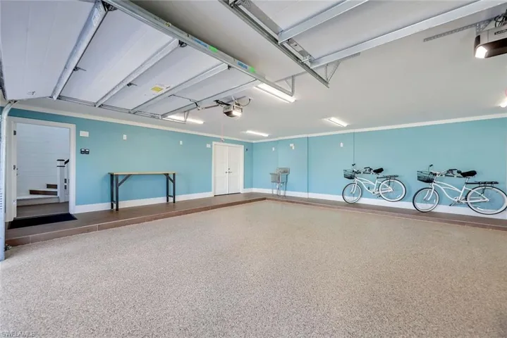 Garage with a garage door opener and baseboards