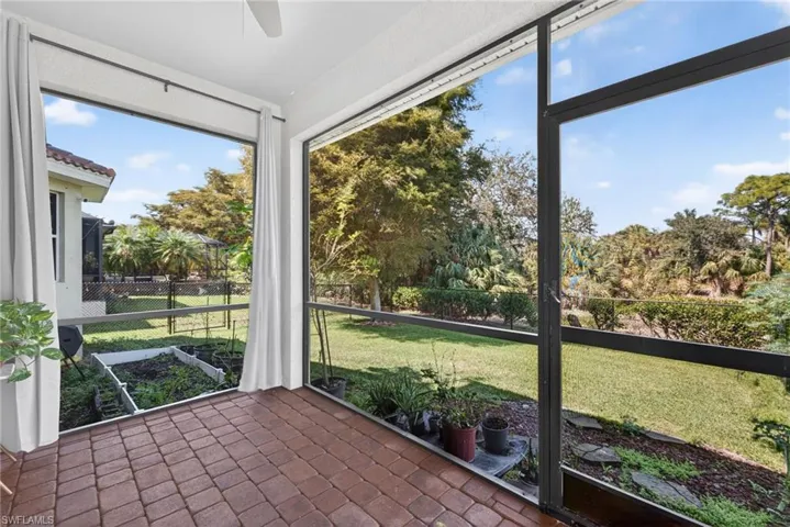 Unfurnished sunroom with brick floors