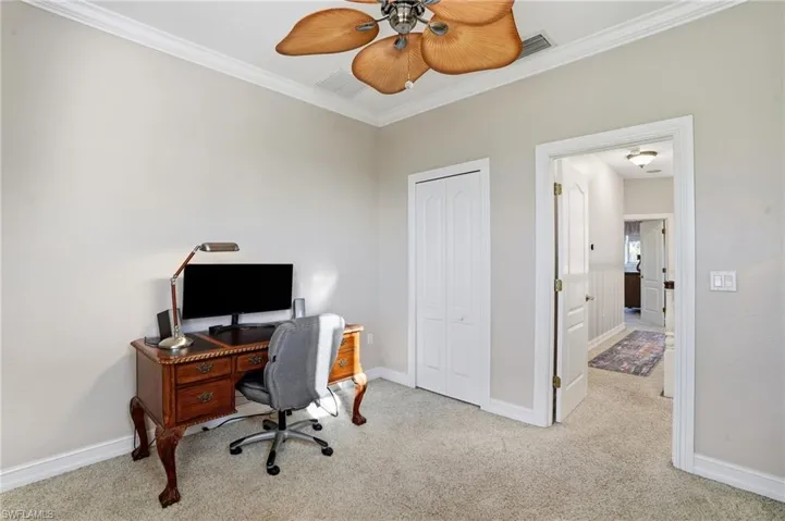 Office area featuring ornamental molding and light carpet