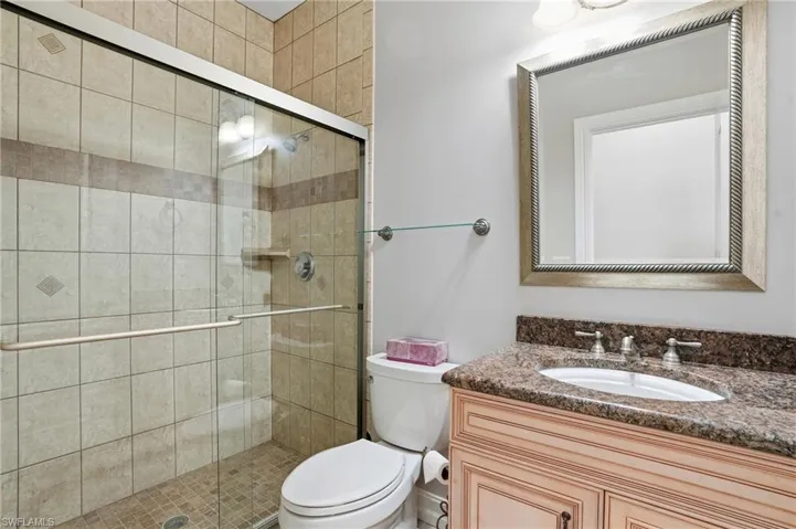 Bathroom featuring a stall shower and vanity