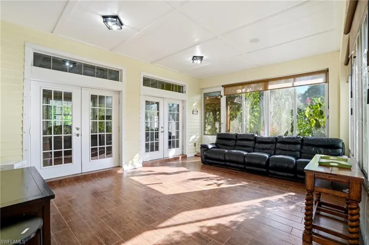 Sunroom / solarium featuring french doors and wood finished floors