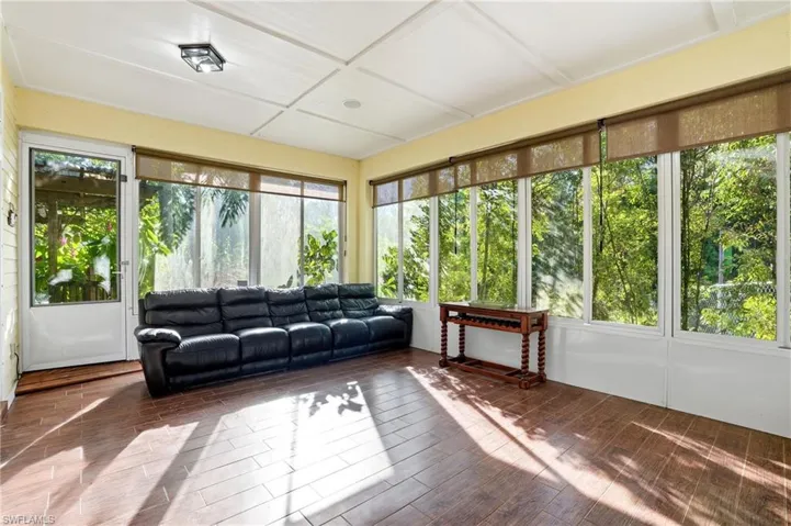 Sunroom / solarium featuring wood finished floors