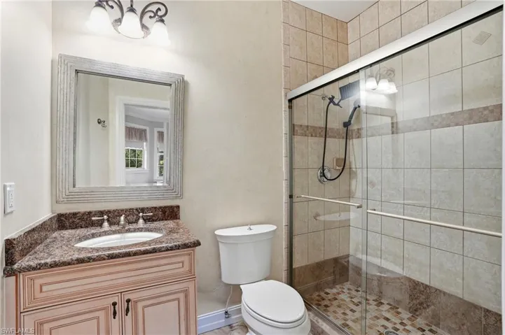 Bathroom featuring a shower stall and vanity
