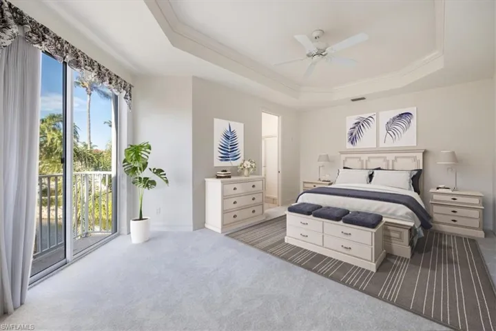 Carpeted bedroom with a raised ceiling, visible vents, ornamental molding, access to outside, and baseboards Virtual