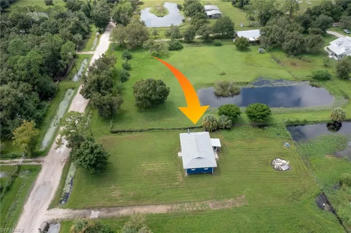 Aerial view featuring a water view and a rural view