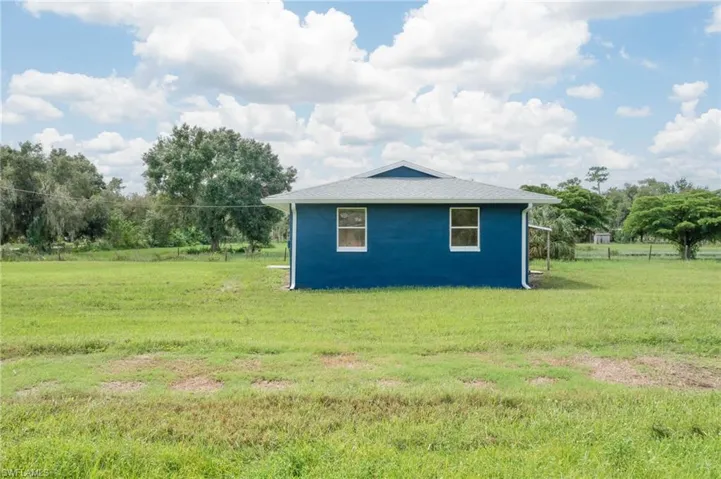 View of outdoor structure with a lawn