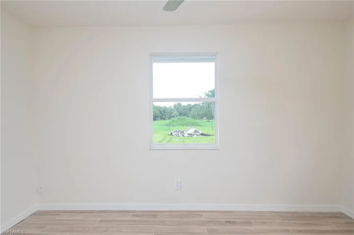 Spare room featuring light wood-type flooring and ceiling fan