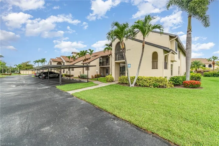 View of property with covered parking