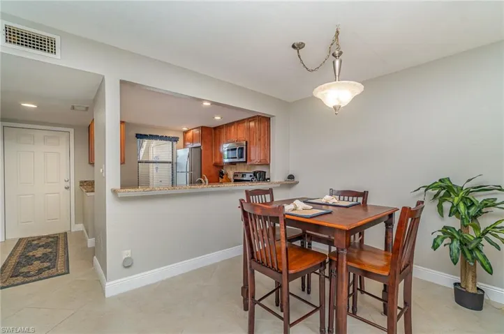 Dining room featuring recessed lighting and light tile patterned floors