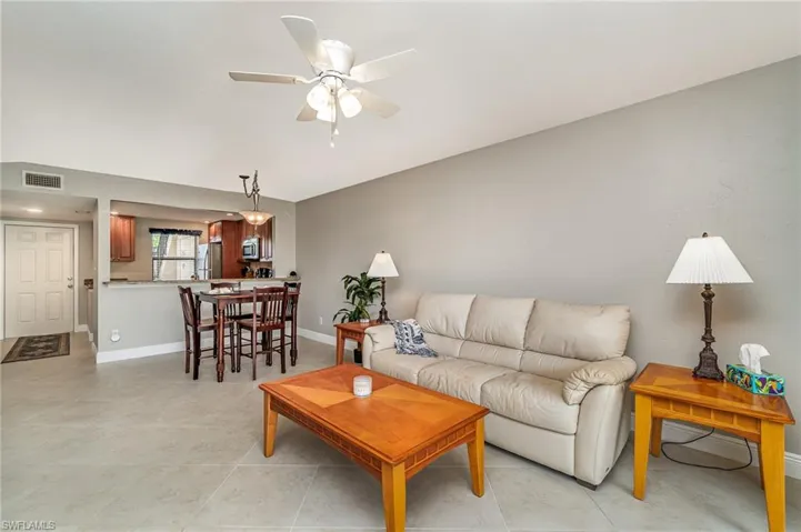 Living room featuring ceiling fan and light tile patterned floors
