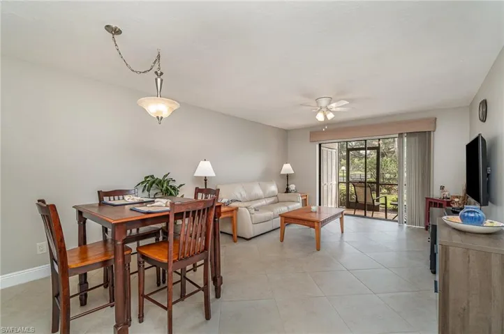 Dining room with ceiling fan and light tile patterned flooring