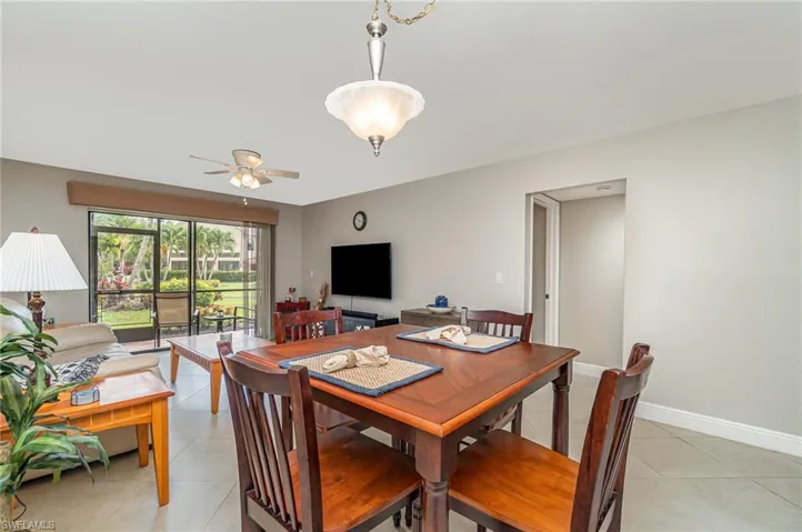 Dining area featuring light tile patterned flooring and a ceiling fan