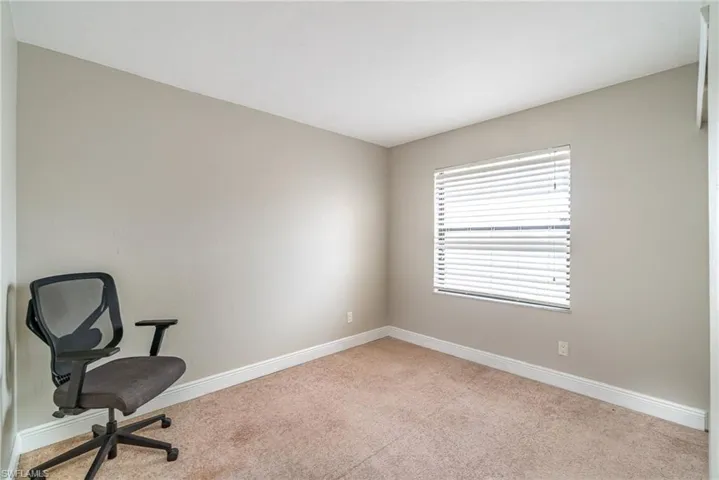 Unfurnished office with baseboards and carpet flooring