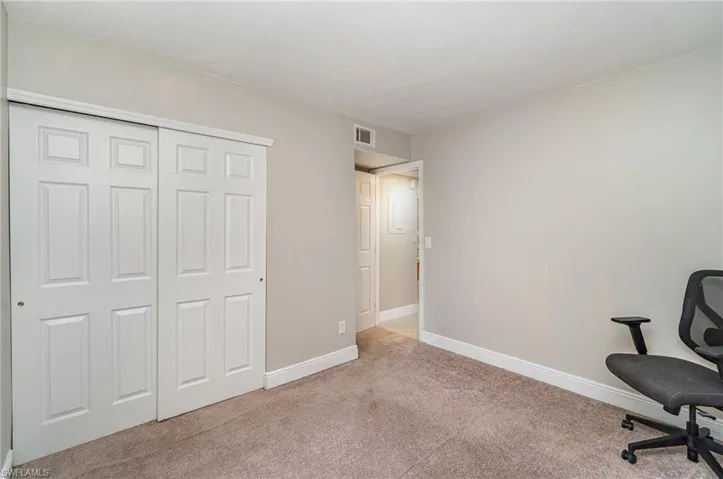 Office featuring light carpet and baseboards