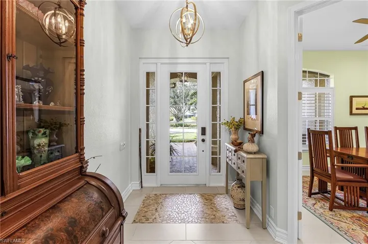 Foyer entry with inlaid pebble tile and glass sidelights