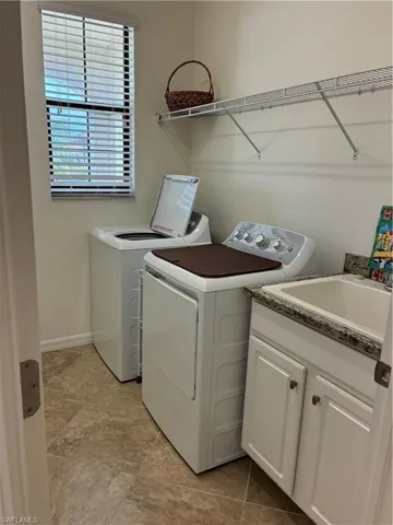 Laundry area with cabinet space and independent washer and dryer
