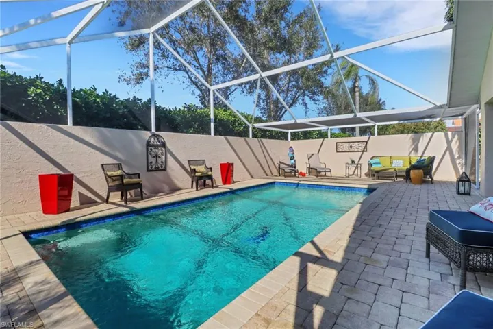 View of swimming pool with a lanai and a patio