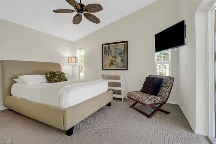 Bedroom featuring lofted ceiling, carpet floors, and ceiling fan