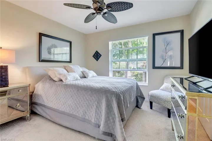 Carpeted bedroom with ceiling fan