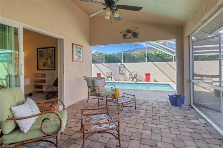 View of patio with ceiling fan and glass enclosure