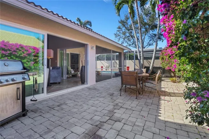 View of patio / terrace with area for grilling and a lanai