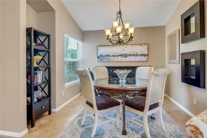 Dining room featuring vaulted ceiling and a chandelier