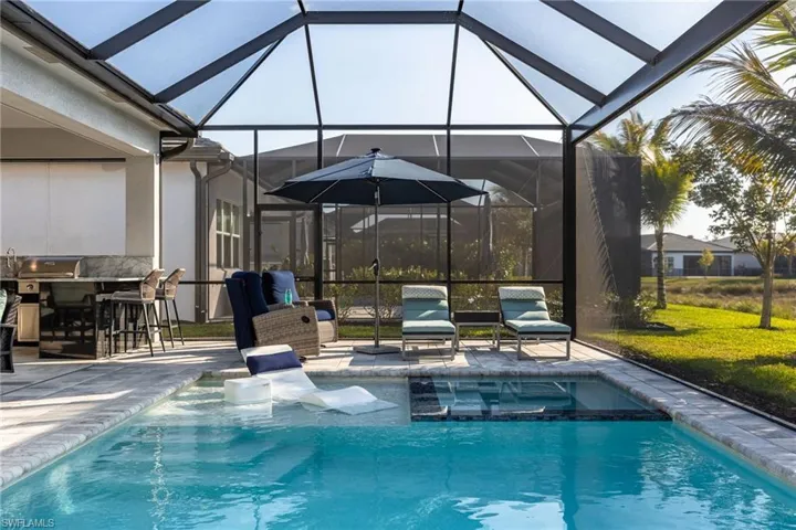 Sun shelf, spa, pool, outdoor kitchen, and outdoor TV
