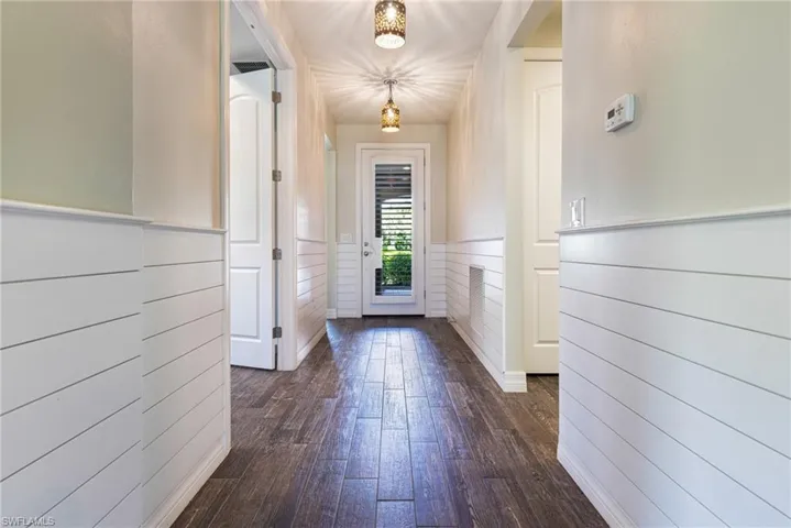 Doorway to outside featuring dark wood-type flooring