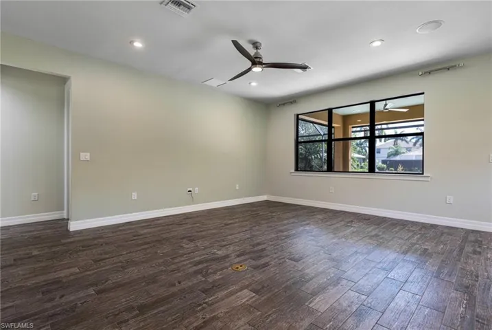 Spare room featuring ceiling fan and dark hardwood / wood-style flooring