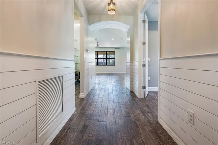 Hall with dark wood-type flooring