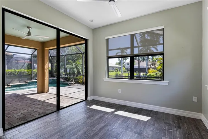 Doorway featuring ceiling fan and hardwood / wood-style flooring