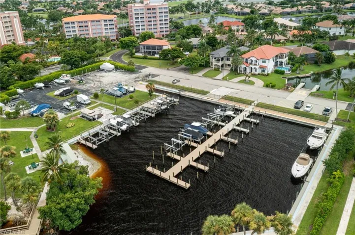 Birds eye view of property with a water view