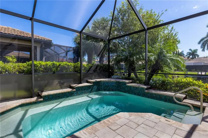 View of pool with glass enclosure