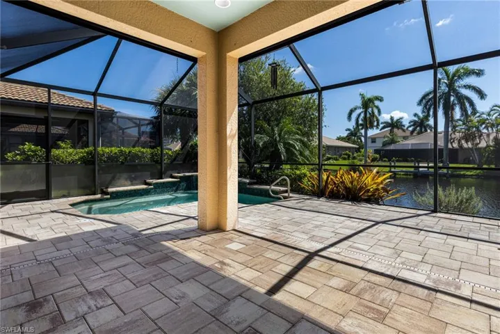 View of pool with a patio area and a lanai
