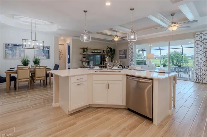 Spacious open-concept interior featuring light wood-finish flooring