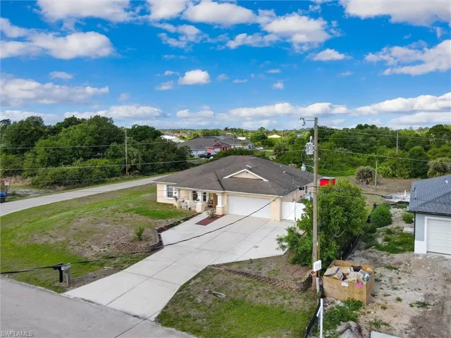 Ranch-style home with a garage and concrete driveway