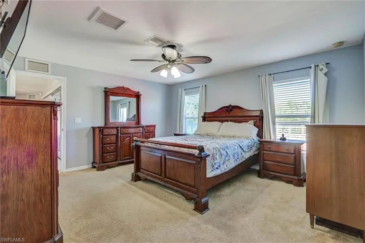 Bedroom featuring light carpet and ceiling fan