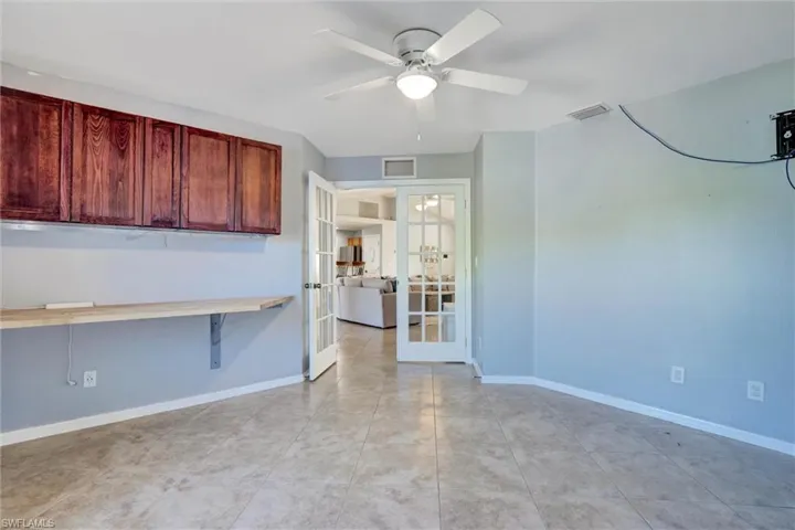 DEN / FLEX SPACE featuring french doors and ceiling fan