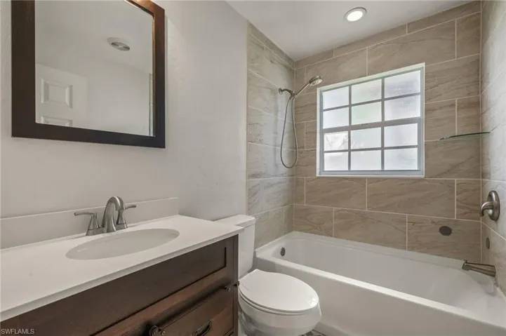 Guest Full bathroom featuring vanity, toilet, and tiled shower / bath