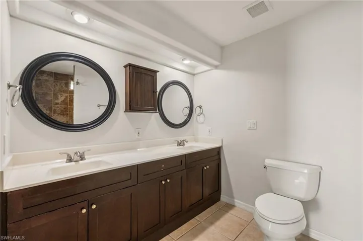Bathroom with tile patterned floors, vanity, and toilet